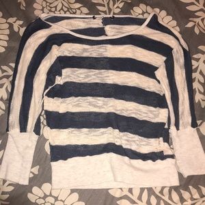A stripped blue and creme colored shirt